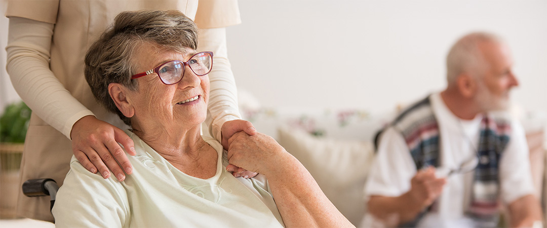 a woman sitting in a chair, holding hands with a nurse